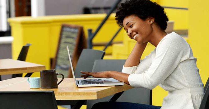 A woman on a computer consolidating her student loans