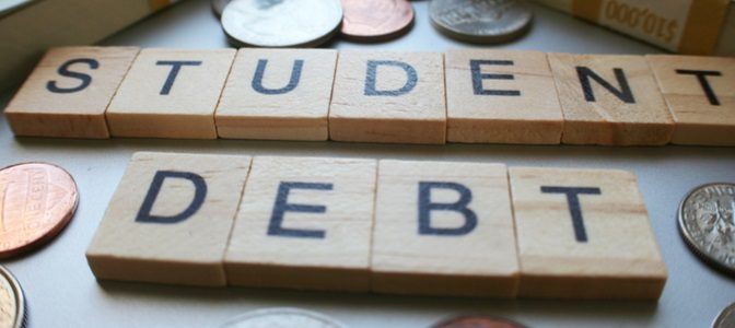 A picture of the words "Student Debt" on a table surrounded by coins