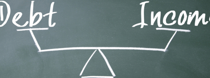 An image of a scale weighing the words debt and income against each other