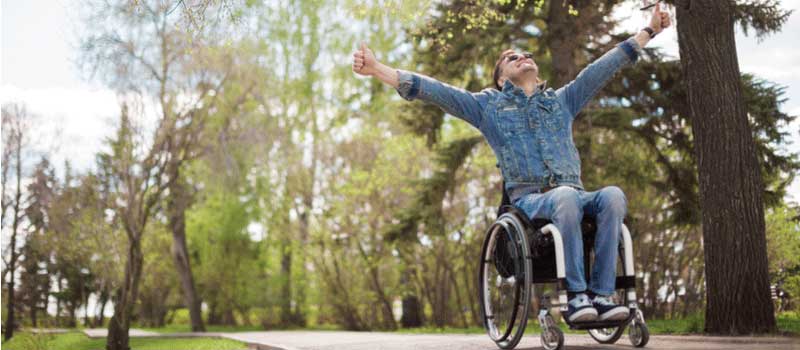 A disabled man in a wheelchair celebrating