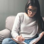 A young girl studying for her masters degree