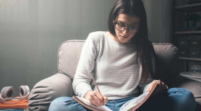 A young girl studying for her masters degree