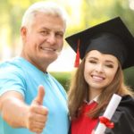a father with his graduating daughter being happy