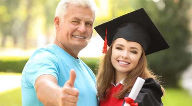 a father with his graduating daughter being happy