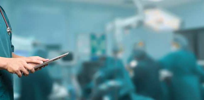 An anesthesiologist with a clipboard in an operating room