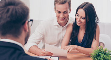 Happy couple doing paperwork