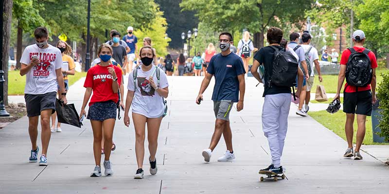 College students on campus walking around with masks on