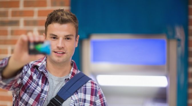 A college student hold a credit card